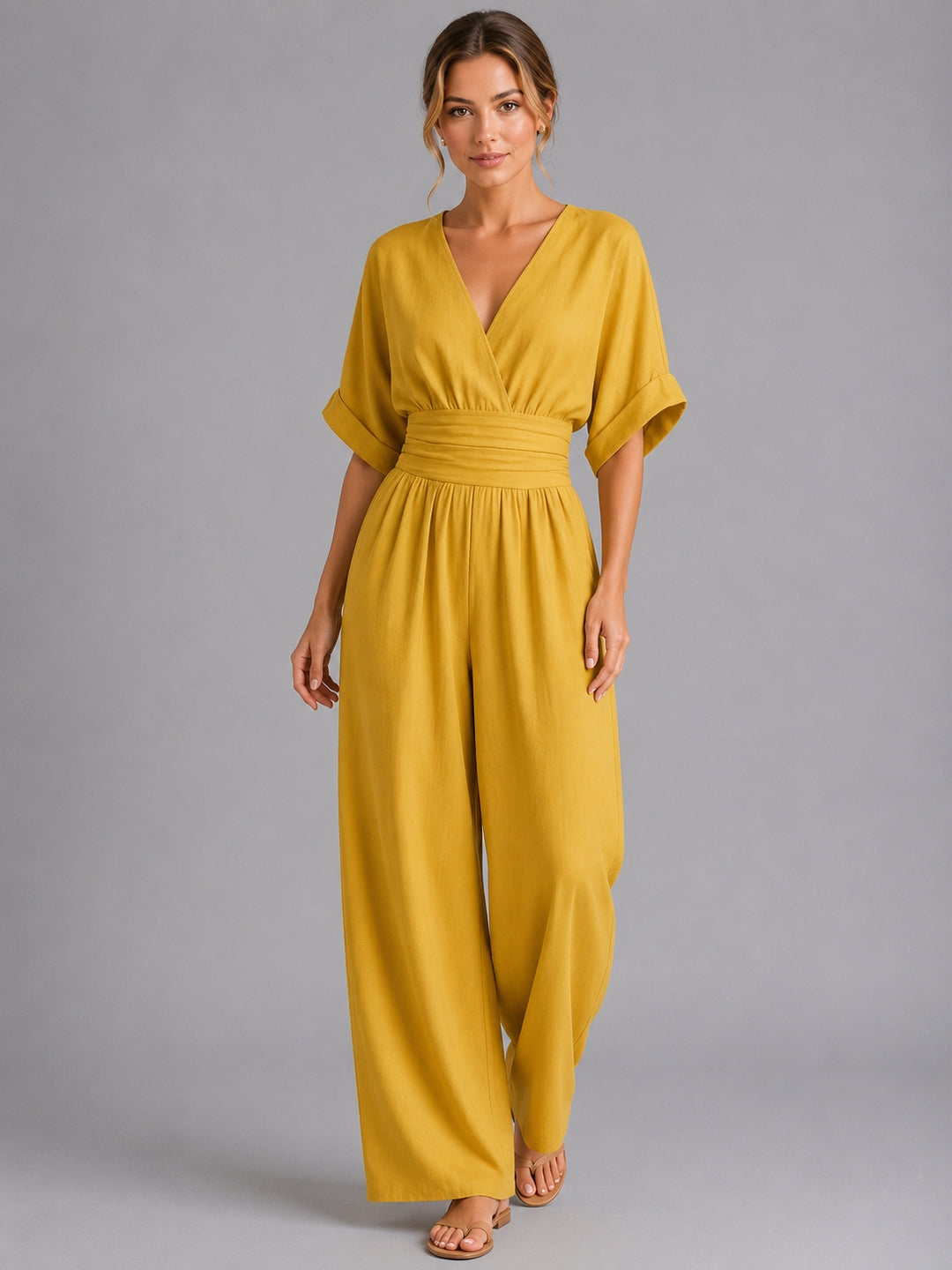 Cinched waist wide-leg jumpsuit, side profile flowing legs