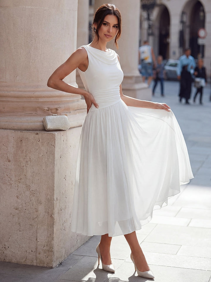 Draped neck pleated midi dress showing flowing skirt, side view